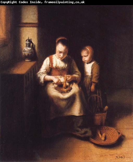 Nicolas Maes A Woman Scraping Parsnips,with a Child Standing by Her